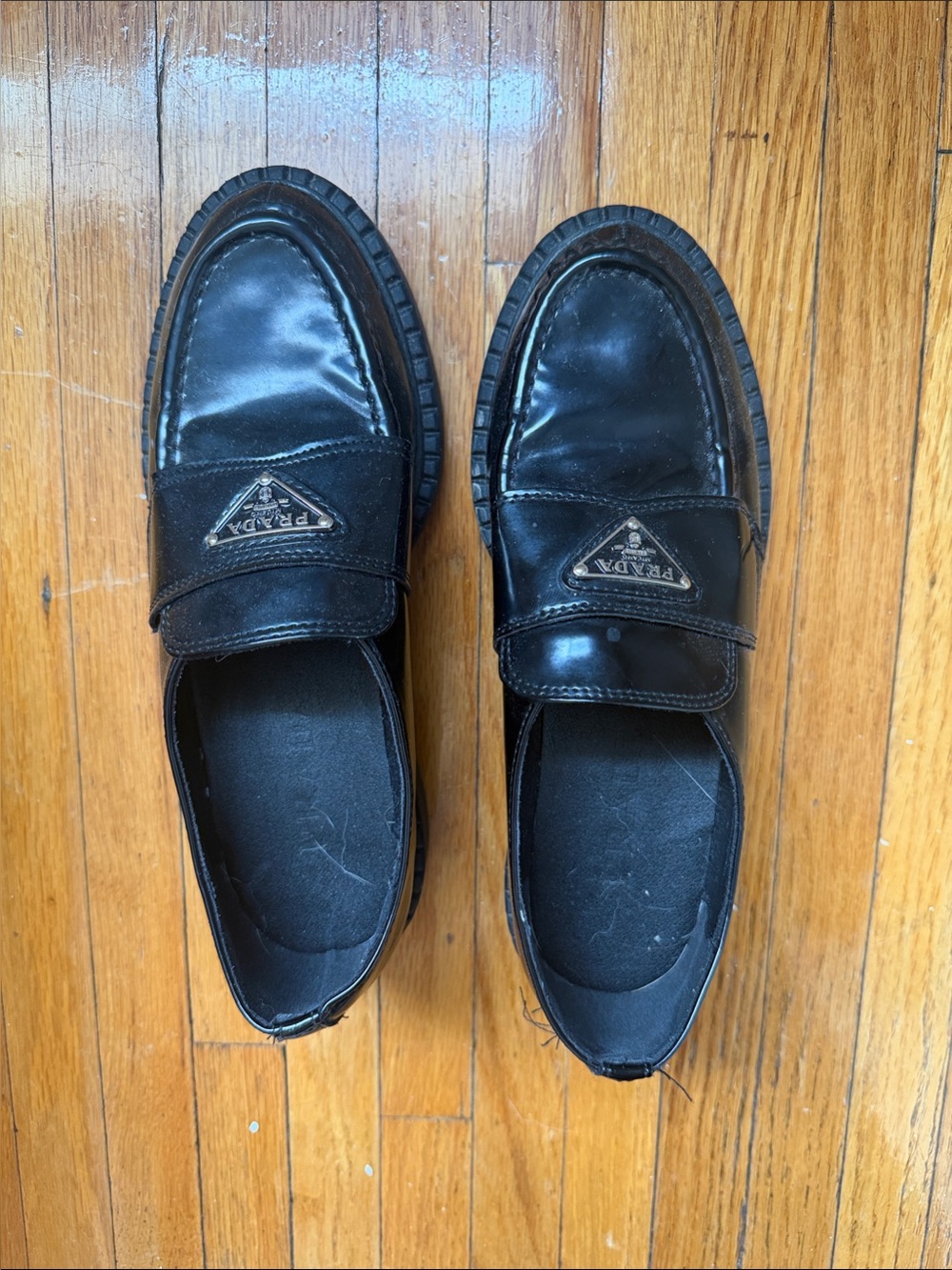 Prada Women’s Black Leather Slip-On Loafers with Logo Plaque